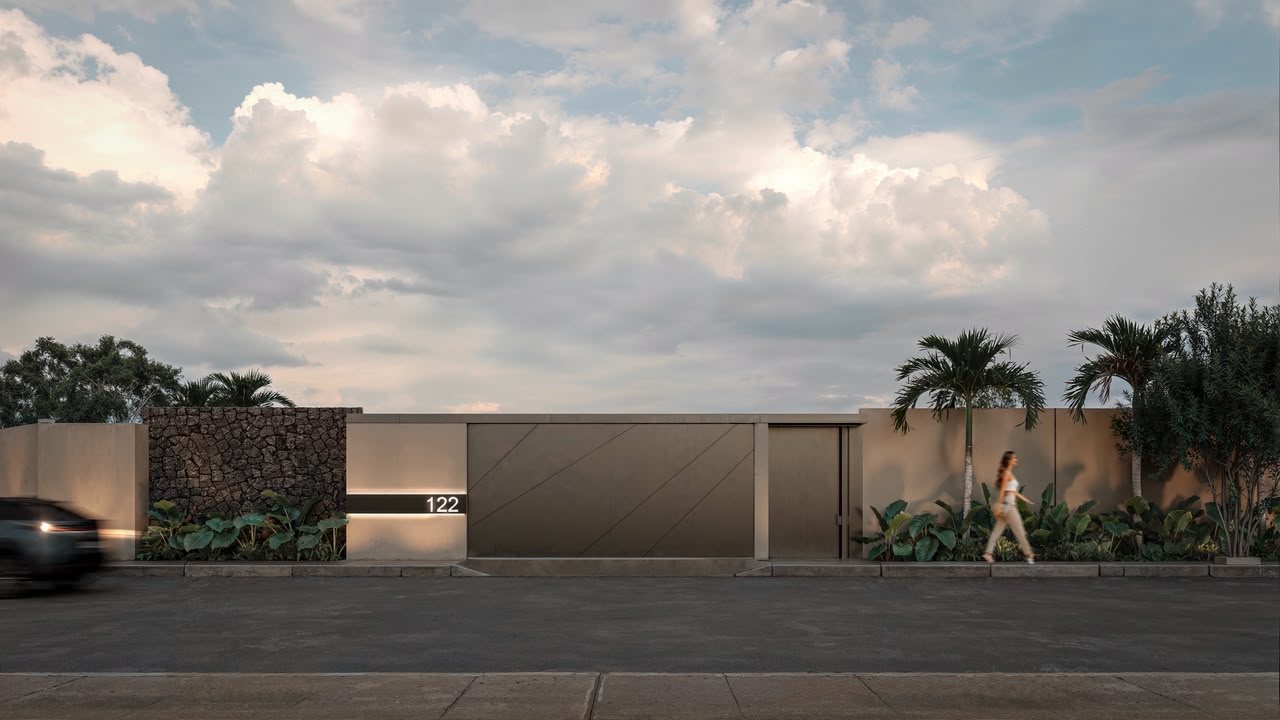 Street facade with volcanic stone wall and pivot gate